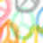 Pixelated abstract composition with overlapping translucent shapes in pink, orange, green, blue, and gray against a white background.