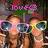 Two people wearing large sunglasses with reflective lenses, one holding a green sign with pink text reading 'love<3' above their heads.