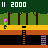 Pixelated game scene with green character, pink head, brown trees, yellow ground, orange ladder, and score '11 2000' on dark green background.