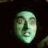 A pixelated green-tinted face on the left side of a split-screen image with white text reading "I'll get you my pretties" on the right against a black background.