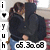 Two figures in dark hooded garments embrace closely, one with light blue pants visible; vertical text on left reads 'i', 'T', '!', 'U', 'h'; bottom displays '05.30.08' in pixelated digits.