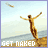 A pixelated beach scene with a person jumping, text reading "GET NAKED" at the bottom, and a small object in the sky.