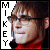 six identical pixelated images showing a person with brown hair and glasses wearing a red turtleneck, with vertical text reading "MIKEY" on the left side