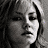 A 48x48 pixel animated contact sheet showing three grayscale and one color frame of a celebrity's face with subtle expression changes across frames.