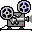 Two pixel-art film projectors with blue-and-black reels, gray bodies, and red indicator lights on a white background.