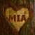 A heart-shaped icon with the text MIA overlaid on a textured brown background.
