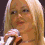 A blonde woman holding a microphone in three sequential poses showing mouth opening and head angle shifts.