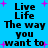 Blue background with black text reading "Live Life The way you want to" repeated in four quadrants, surrounded by pink plus signs.