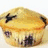 Two side-by-side muffins with blueberry toppings, one displaying red text overlay reading 'MUFFINS!' in pixelated font.