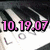 Pixelated image showing pink digital text '10.19.07' with black outlines over a blurred background of dark and light tones.