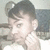 Pixelated static image of a person with short dark hair, light skin tone, and visible ear against muted background.