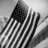 Black and white pixelated image showing a stylized flag with diagonal stripes on the left side transitioning to vertical stripes on the right, set against a gradient background.
