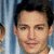 A pixelated portrait of a person with dark hair against blue curtains, showing subtle facial expression changes across frames.