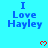 Blue text "I Love Hayley" on cyan background with red pixel hearts, gray rectangle partially obscuring bottom-right corner.