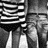 Black-and-white pixelated image showing a figure in striped clothing with vertical lines and a blurred background.