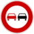 Red circular traffic sign with white background containing two stylized cars, one red and one black, positioned side-by-side.