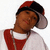 Static pixelated image of a person wearing red and black headphones, white shirt with red vest, against plain background.