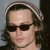 A pixelated image of a person wearing sunglasses and a light-colored beanie, with text reading 'love the BEANIE' on a black background.