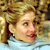 Static 50x50 pixel buddy icon showing a close-up of a person with blonde hair and red lips against a blurred background.