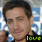 Pixelated close-up of a person with short brown hair wearing a dark shirt, with a blue and white patterned background and yellow text reading 'love' at the bottom right.