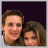 Two people with long brown hair pose closely together against a dark purple background, text above them changes from 'I'll be' to 'my boost' in blue pixelated font.
