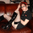 Pixelated image of a person with red hair in a black shirt and black boots, holding a guitar on a brown couch with red text reading "He Looks Hot In" and "them damn Boots!"