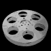 Six grayscale film reels arranged in two of three, each reel showing distinct perforation patterns and central hub details against a black background