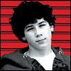 A black-and-white portrait of a person with curly hair against a red striped background, wearing a dark jacket over a white shirt.
