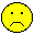 Three yellow pixelated smiley faces with black outlines on gray background: top-left frowns, top-right and bottom smiles.