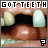 A mouth with teeth and a missing tooth, displaying 'GOT TEETH' text above and a question mark below, in a of four