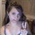 A pixelated static image shows a person with dark hair holding up two fingers in front of a blurred background.