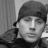 Black-and-white photo of a person wearing a dark beanie and jacket on the left, next to bright pink background with white pixelated text reading "I LOVE Channing Tatum" on the right.