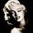 Pixelated grayscale image of a woman's face with voluminous hair, visible in profile and three-quarter view against black background.
