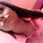 Pixelated close-up of a person's face with dark hair, closed eyes, and pink-toned background.
