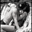 Black-and-white pixelated image of two people embracing, with green text reading "OWW... i wish this could be me" on a black background.