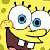 Pixelated yellow cartoon character with large blue eyes, white teeth, brown shorts, and a yellow background with green patches.