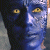 Pixelated blue-skinned figure with yellow eyes on left, green background with "Original Icons .com" text on right.
