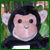 Pixelated image of a monkey with dark fur, light pink face, and small black eyes, set against a green and brown background with a white rectangular shape below.