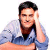 A pixelated image of a person with dark hair wearing a blue and white striped shirt, holding a hand to their head in a gesture.