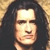 Static pixelated image of a person with long dark hair against a light brown background, showing a neutral facial expression.