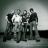 Static 48x48 pixel icon showing a group of five figures in grayscale tones with one figure holding a bright white object, set against a gradient background.
