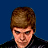 Pixelated image of a person with light brown hair and fair skin against solid blue background, wearing dark clothing.