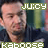 A pixelated image of a person with short dark hair wearing a dark blue shirt, with green text overlays reading 'JUICY' and 'Kaboose' in blocky font.