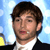 Static pixelated image of a person with brown hair wearing a black suit and white shirt against a blue sky background.