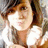 Pixelated static image of a person with brown hair wearing a white top, visible from the shoulders up against a blurred background.