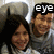 Two people in gray shirts pose together; text above changes from 'eye' to 'luv' then disappears, while the lower-left text reads 'gracie'.