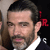 Static pixelated image of a man's face with dark hair, beard stubble, and red text 'JR' on the right side against black background.