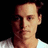 Pixelated image of a person with dark hair and a white shirt on a black background, next to green text reading 'ur just jealous because johnny depp is sexier than you'.