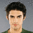 Pixelated image of a person with dark hair and green clothing against gray background, next to black with white text "Milo"