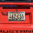 Red rectangular object with multiple displaying text and images, including "AUSTEN" and "MAYBE IT'S ME", in a